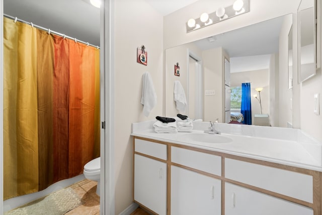 bathroom with vanity, toilet, and tile patterned flooring