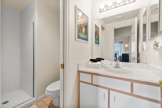 12800 Melville Dr Unit A313, Montgomery, TX 77356 - bathroom featuring tile patterned flooring, vanity, toilet, a stall shower, and visible vents