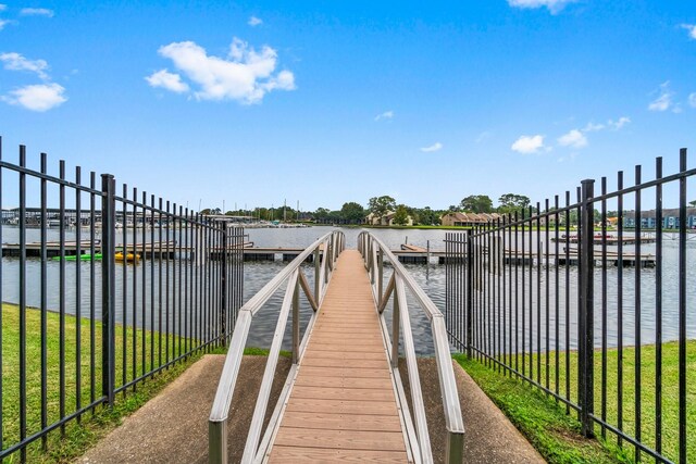 dock area featuring a water view and a yard