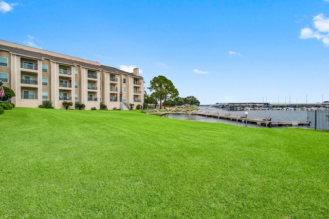 exterior space featuring a water view and a lawn