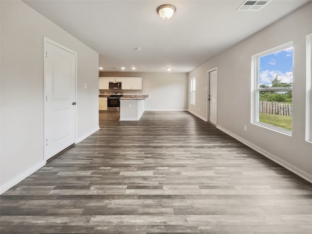 unfurnished living room with wood-type flooring