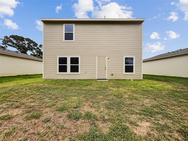 rear view of house with a yard