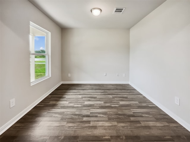 spare room with dark hardwood / wood-style floors