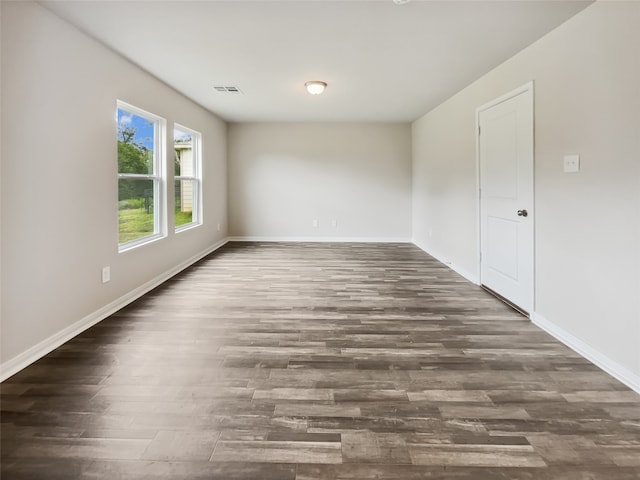 unfurnished room featuring dark hardwood / wood-style flooring