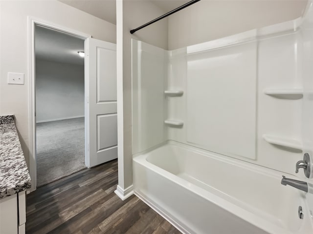 bathroom featuring shower / bath combination, hardwood / wood-style flooring, and vanity