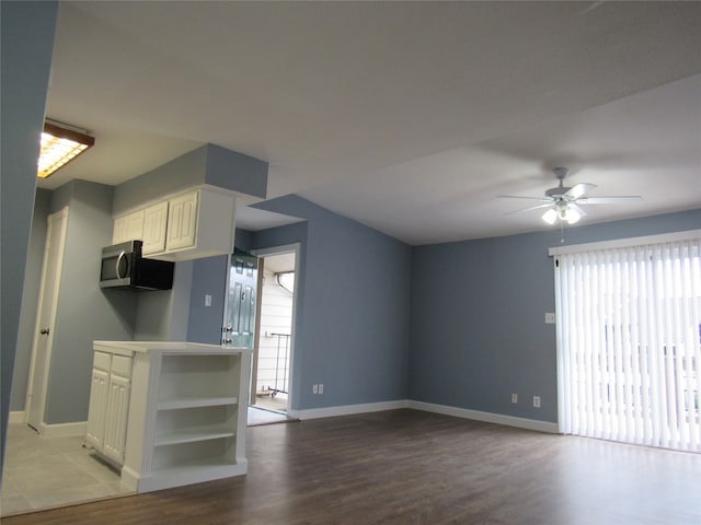 kitchen with plenty of natural light, light hardwood / wood-style flooring, ceiling fan, and white cabinetry