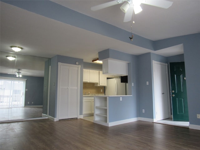 kitchen with dark hardwood / wood-style floors, white cabinets, ceiling fan, and white fridge