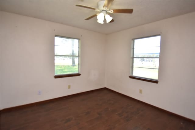 unfurnished room featuring dark hardwood / wood-style floors and ceiling fan