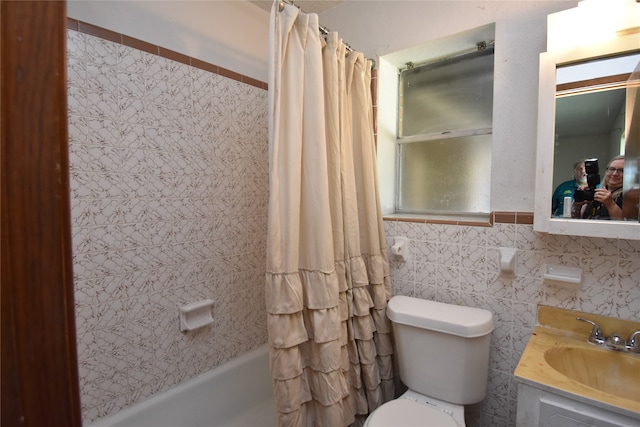 full bathroom with tile walls, vanity, toilet, and shower / bathtub combination with curtain