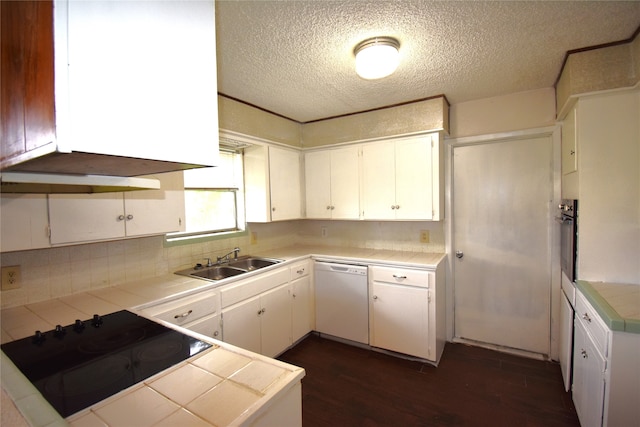 kitchen featuring dark wood-type flooring, white cabinets, tile countertops, black appliances, and sink