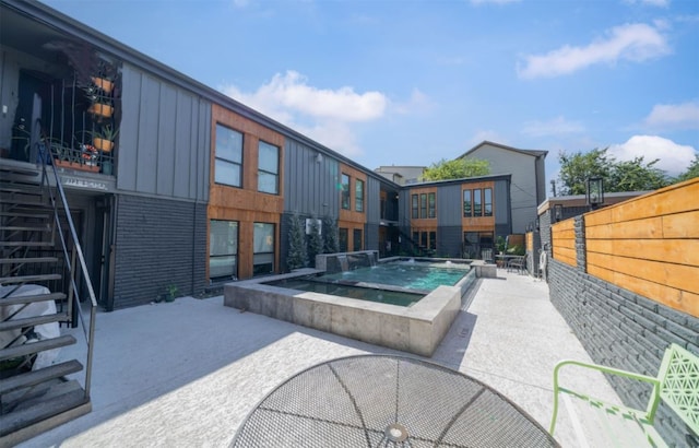 view of swimming pool with a patio and an in ground hot tub