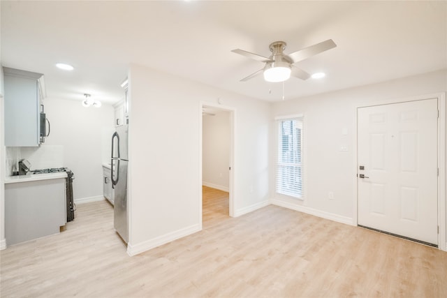 interior space featuring light wood-type flooring and ceiling fan