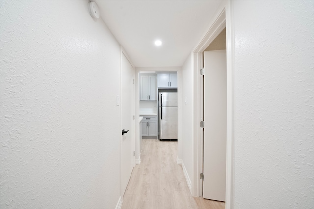 hall with light hardwood / wood-style flooring