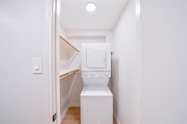 laundry room featuring stacked washer and clothes dryer