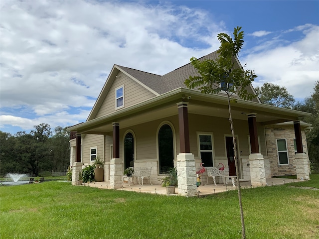 view of front of property with a porch and a front lawn