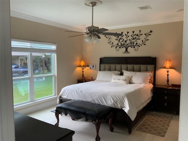 tiled bedroom with ceiling fan and crown molding