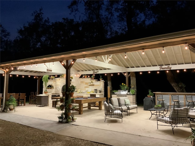 patio at twilight featuring an outdoor hangout area