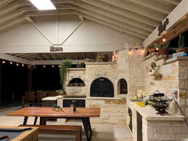 view of patio featuring an outdoor stone fireplace