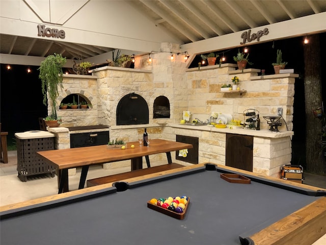 rec room with high vaulted ceiling, billiards, an outdoor stone fireplace, and beam ceiling