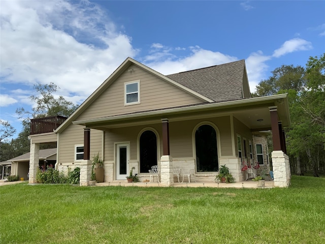 view of front of house featuring covered porch and a front yard