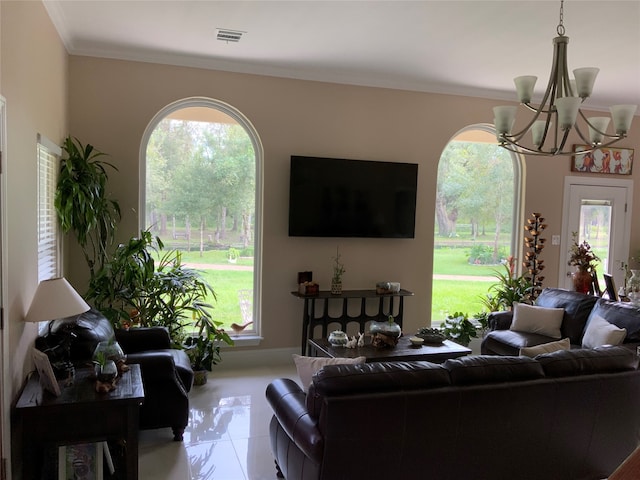 living room featuring ornamental molding, a notable chandelier, and tile patterned flooring