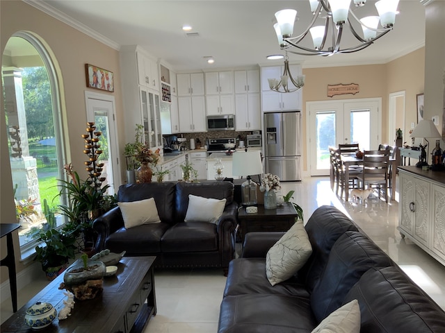 living room featuring crown molding, french doors, and a notable chandelier