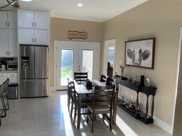 tiled dining area featuring french doors and ornamental molding