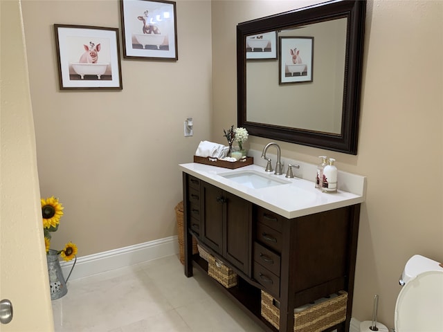 bathroom featuring vanity, toilet, and tile patterned flooring