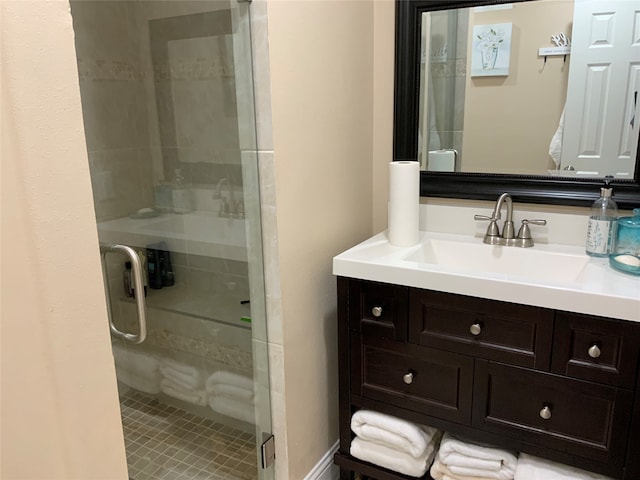 bathroom with vanity and a shower with shower door