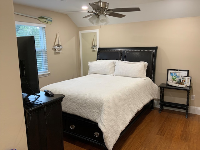 bedroom featuring dark wood-type flooring, ceiling fan, and vaulted ceiling