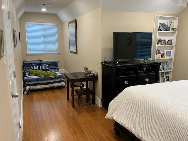 bedroom featuring vaulted ceiling and wood-type flooring