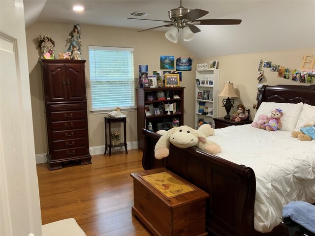 bedroom with dark hardwood / wood-style flooring, ceiling fan, and lofted ceiling