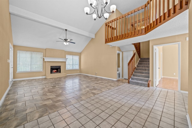 unfurnished living room featuring a fireplace, ceiling fan with notable chandelier, tile patterned flooring, and beamed ceiling