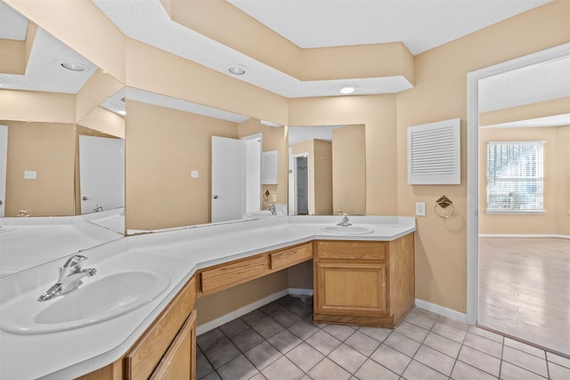 bathroom with tile patterned flooring and vanity