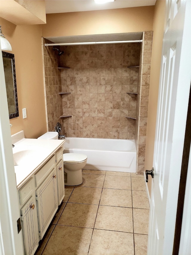 full bathroom with tile patterned flooring, tiled shower / bath, toilet, and vanity