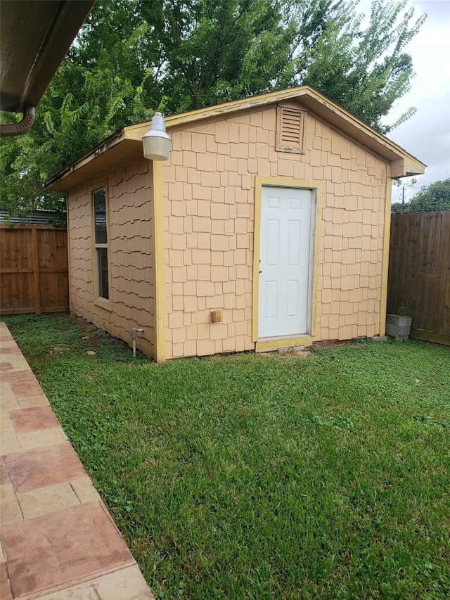 view of outdoor structure featuring a lawn