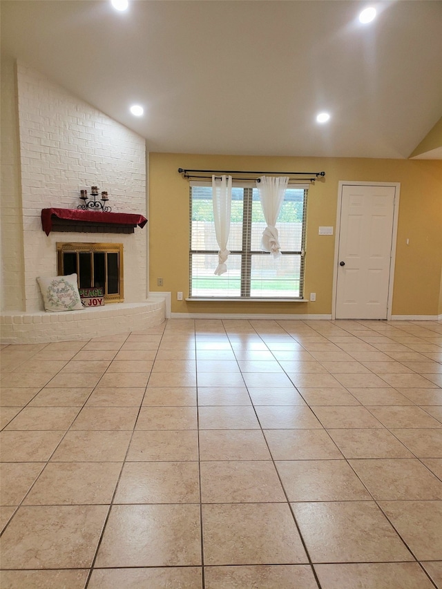 unfurnished living room with a fireplace and light tile patterned flooring