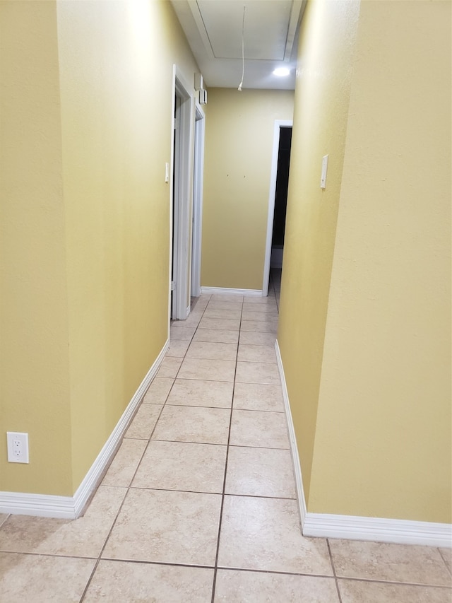 corridor featuring light tile patterned flooring