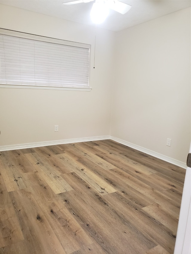 empty room featuring ceiling fan and hardwood / wood-style flooring