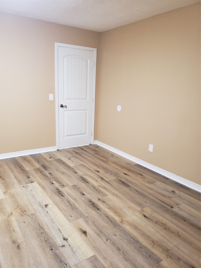 empty room with light hardwood / wood-style floors