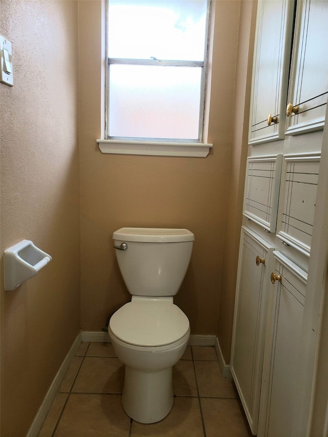 bathroom featuring toilet and tile patterned floors