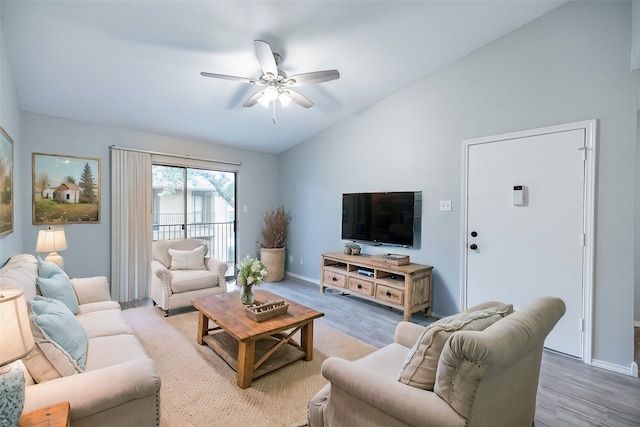 living room with ceiling fan, vaulted ceiling, and wood-type flooring