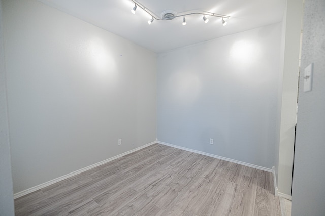 unfurnished room with light hardwood / wood-style floors and track lighting