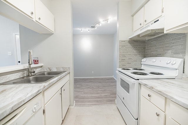 kitchen featuring tasteful backsplash, white cabinets, white appliances, light tile patterned floors, and sink