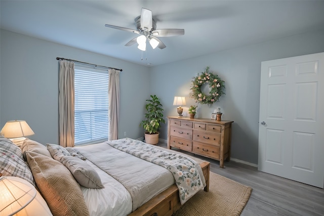 bedroom with light wood-type flooring and ceiling fan