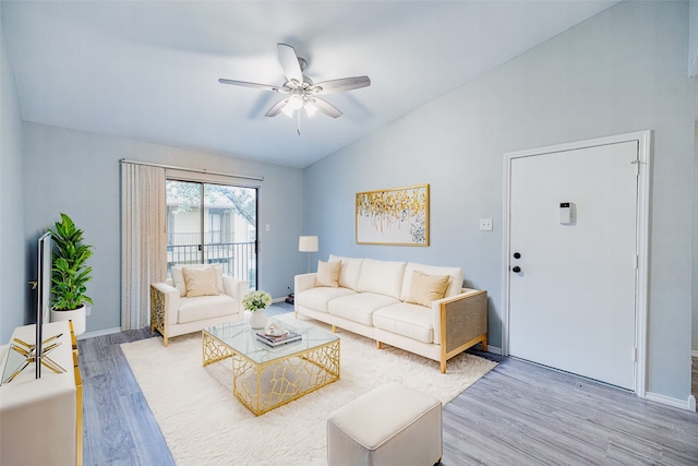 living room featuring vaulted ceiling, ceiling fan, and hardwood / wood-style flooring