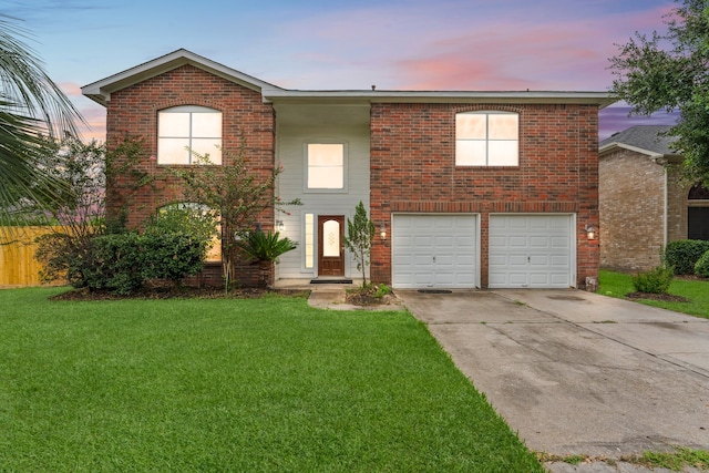 view of front of property with a lawn and a garage