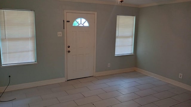 entryway featuring crown molding and light tile patterned floors