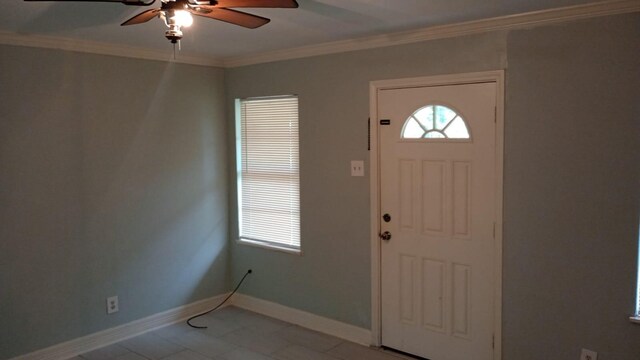 foyer entrance with crown molding and ceiling fan