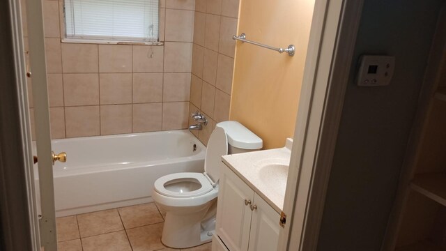 full bathroom with tiled shower / bath, vanity, toilet, and tile patterned flooring